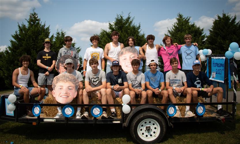 Students celebrate while on a homecoming parade float